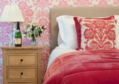 Champagne with glasses on bedside table or Tamar bedroom